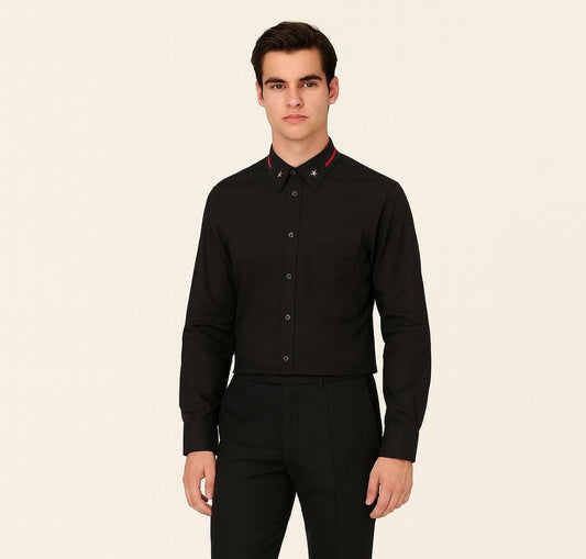 Man wearing a black dress shirt with red accents on a beige background